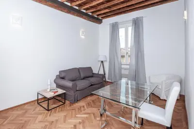 a living room with a glass table and a couch at Trastevere Wonderful 3BR Apartment in Rome