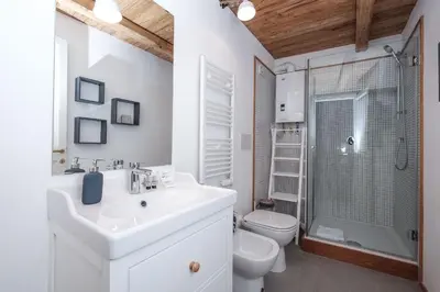 a bathroom with a sink and a toilet and a shower at Trastevere Wonderful 3BR Apartment in Rome