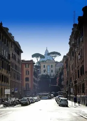 a city street with cars parked in front of a building at St. Peter Loft in Rome