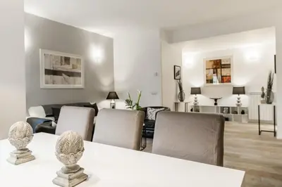 a living room with a white table and chairs at Thebestinrome Vite in Rome