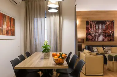 a dining room and living room with a table and chairs at Thebestinrome Vite in Rome