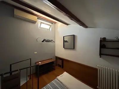 a room with a staircase with a window on the wall at The Queen in Rome