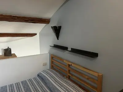 a bedroom with a bed with a wooden headboard at The Queen in Rome