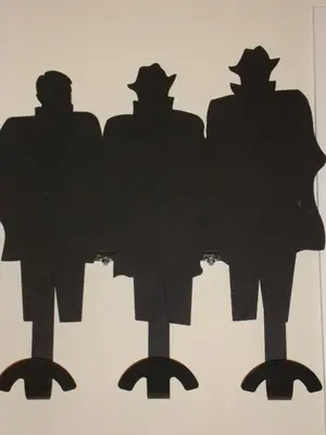 a silhouette of four people on a wall at The Queen in Rome