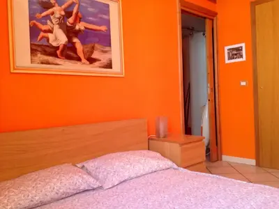 a table in a room with a green wall at Modì Apartment in Rome