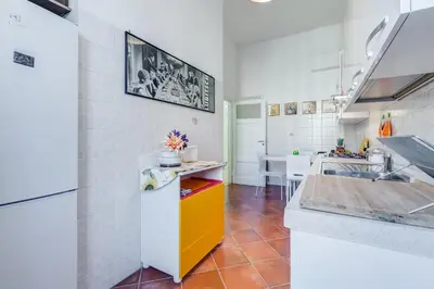 a kitchen with a sink and a refrigerator at Domus Eugenia in Rome