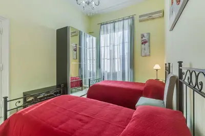 a bedroom with two beds and a window at Domus Eugenia in Rome
