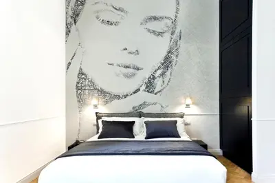 a bedroom with a black and white portrait of a woman at Vanity Navona in Rome