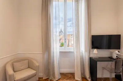 a room with a window with a chair and a television at Vanity Navona in Rome
