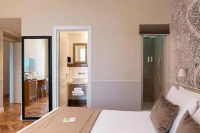 a bedroom with a large bed and a bathroom at Vanity Navona in Rome