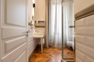 a white bathroom with a sink and a toilet at Vanity Navona in Rome