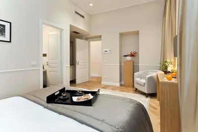a bedroom with a bed with a tray of food on it at Vanity Navona in Rome