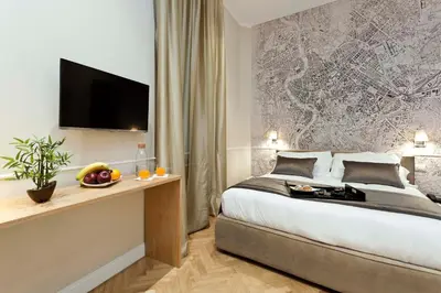 a hotel room with a bed and a tv on a wall at Vanity Navona in Rome