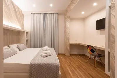 a hotel room with a bed and a chair at Top Floor Colosseo Guesthouse in Rome