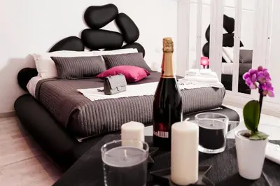 a room with a bed and a bottle of wine at Two Chic Guesthouse in Rome