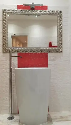 a mirror above a white toilet in a bathroom at Two Chic Guesthouse in Rome