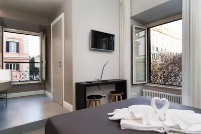 a bedroom with a bed and a large window at Ovidio Suite in Rome