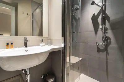 a bathroom with a sink and a shower at Ovidio Suite in Rome