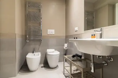 a bathroom with a sink and a toilet at Ovidio Suite in Rome