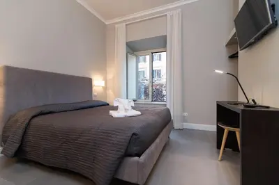 a bedroom with a bed with a teddy bear on it at Ovidio Suite in Rome