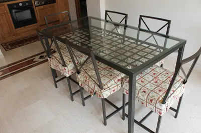 a glass dining table with two chairs at Monnalisa Home in Rome