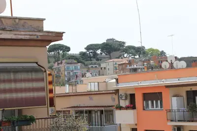 a group of buildings on a hill with trees at Monnalisa Home in Rome