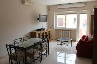 a living room with a table and chairs and a tv at Monnalisa Home in Rome