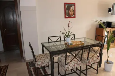 a dining room table and chairs with a glass top at Monnalisa Home in Rome