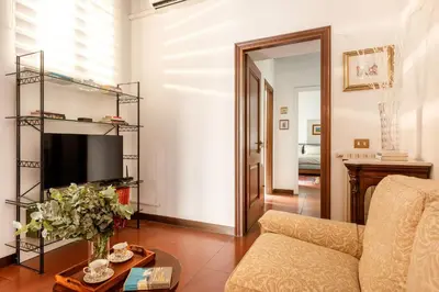a living room with a couch and a television at Annemary Maison in Rome