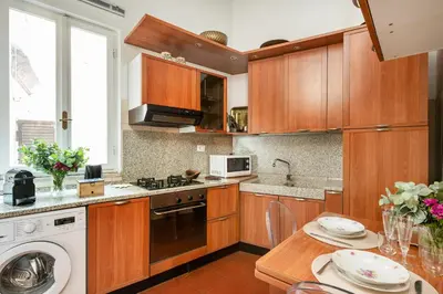 a kitchen with wooden cabinets and a dishwasher at Annemary Maison in Rome