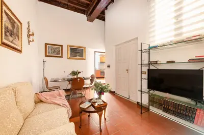 a living room with a couch and a flat screen tv at Annemary Maison in Rome