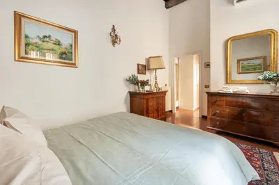a bedroom with a bed and a dresser and a mirror at Annemary Maison in Rome