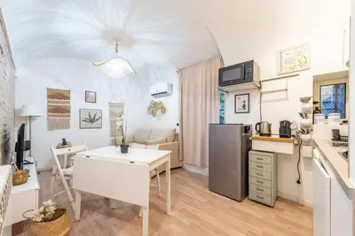a kitchen with a table and a refrigerator at BHM Urban House Pigneto in Rome