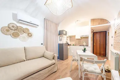 a living room with a couch and a kitchen at BHM Urban House Pigneto in Rome
