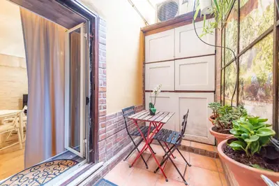 a small balcony with a table and chairs on it at BHM Urban House Pigneto in Rome