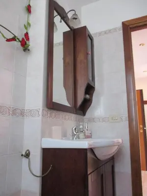 a bathroom with a sink and a mirror at A.B Battistini Short Let's in Rome