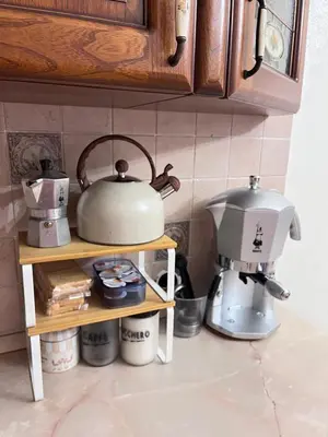 a kitchen counter with a tea kettle and a coffee maker at A.B Battistini Short Let's in Rome
