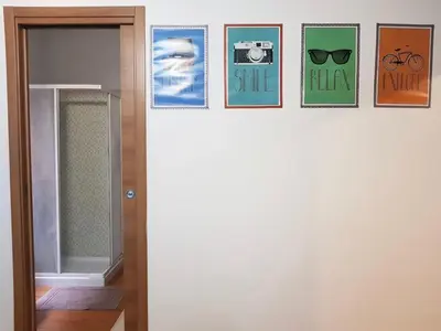 a row of pictures on a wall next to a door at Vatican Area Flat in Rome