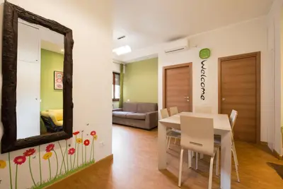 a dining room with a mirror and a table at Vatican Area Flat in Rome