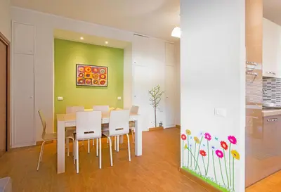 a dining room with a white table and white chairs at Vatican Area Flat in Rome