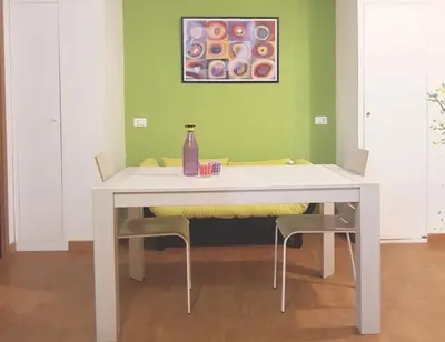 a white table with two chairs and a bottle on it at Vatican Area Flat in Rome