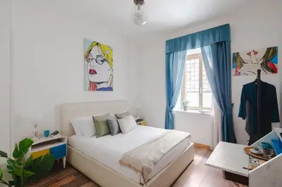 a bedroom with a bed and a painting on the wall at B&B Ibiscus in Rome