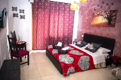 a bedroom with a bed with a red and black blanket at Coffee And The City in Rome
