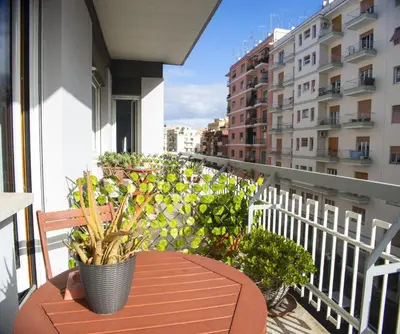 a balcony with a table and potted plants on it at Coffee And The City in Rome