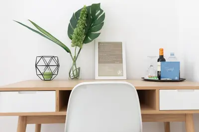 a table with a plant and a vase on it at A+ Bed and Breakfast in Rome