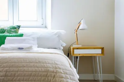 a bedroom with a bed and a lamp on a night stand at A+ Bed and Breakfast in Rome