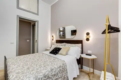 a bedroom with a bed and a tv on the wall at BDC - The Choice, your 2-Bdr apt in Vatican district in Rome