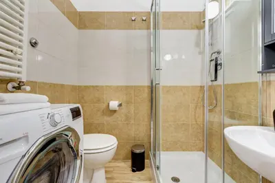 a bathroom with a toilet sink and a washing machine at BDC - The Choice, your 2-Bdr apt in Vatican district in Rome