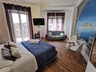 a bedroom with a king sized bed and a couch at La Finestra Sul Mondo B&B in Rome