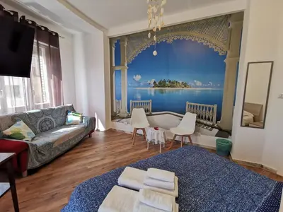 a living room with a large painting on the wall at La Finestra Sul Mondo B&B in Rome